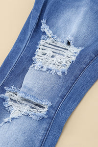 Jeans a gamba svasata effetto vissuto con tasche