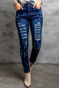 Jeans skinny effetto consumato a vita media